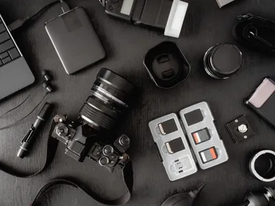 Camera gear laid out on a dark surface