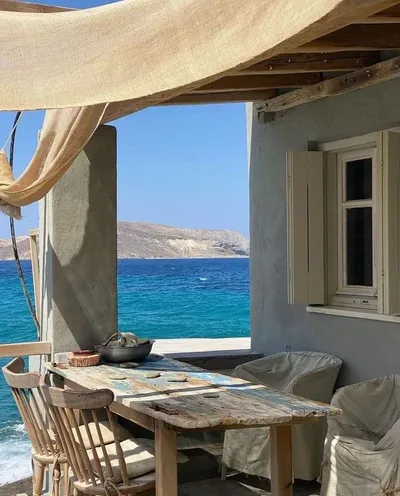 Shaded seaside terrace with a dining table