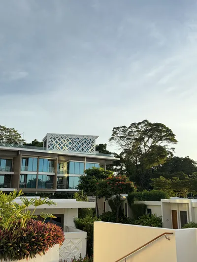 Hotel building surrounded by trees at dusk