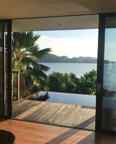 Villa living room opening onto an infinity pool